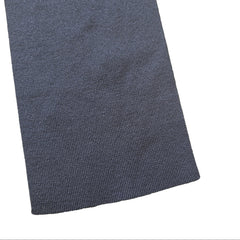 Grey textured fabric on a beige tiled floor