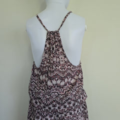 Patterned dress on a mannequin against a plain background