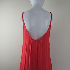 Red dress on a mannequin against a plain background