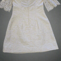 White lace dress on a tiled floor