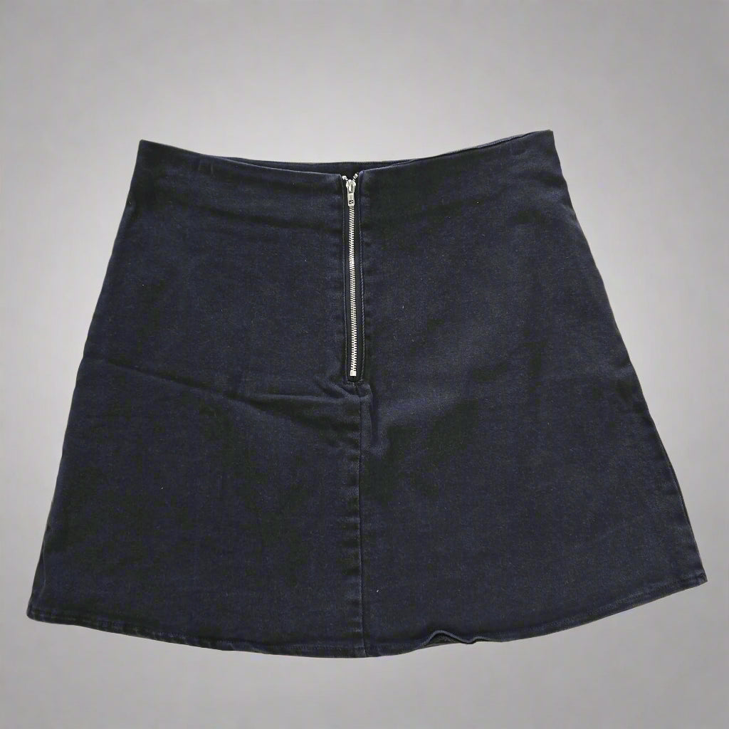 Black skirt with a zipper on a tiled floor