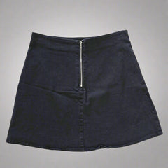 Black skirt with a zipper on a tiled floor