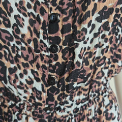 Leopard print fabric with buttons on a close-up view