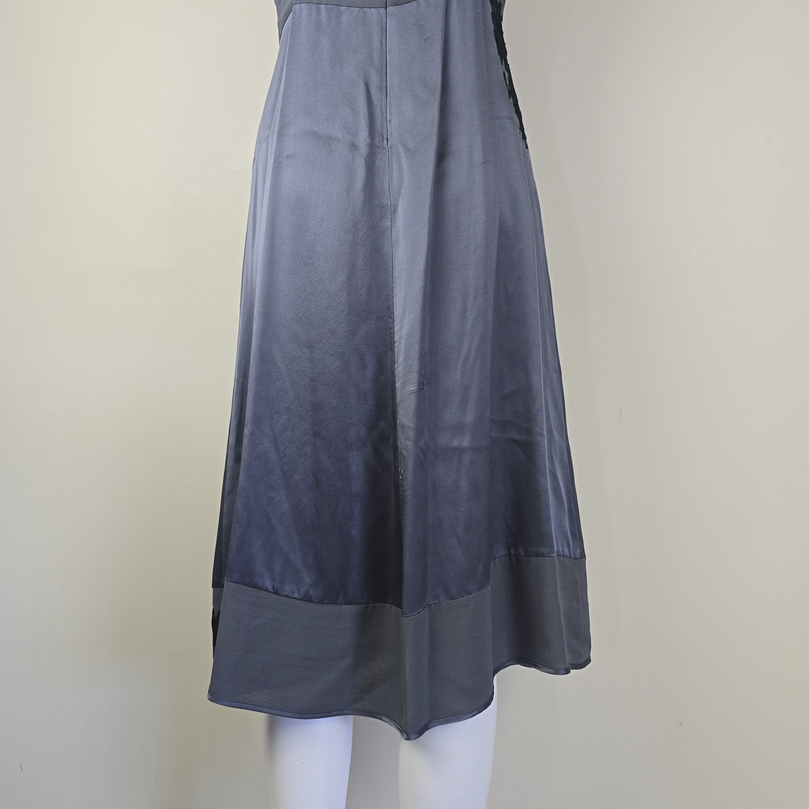 Grey dress with black floral patterns on a light background.