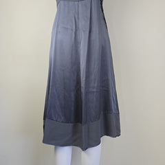 Grey dress with black floral patterns on a light background.