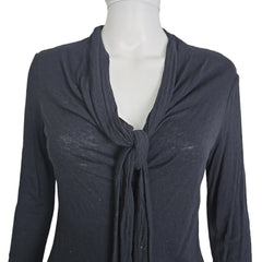 Black top on a mannequin against a beige background