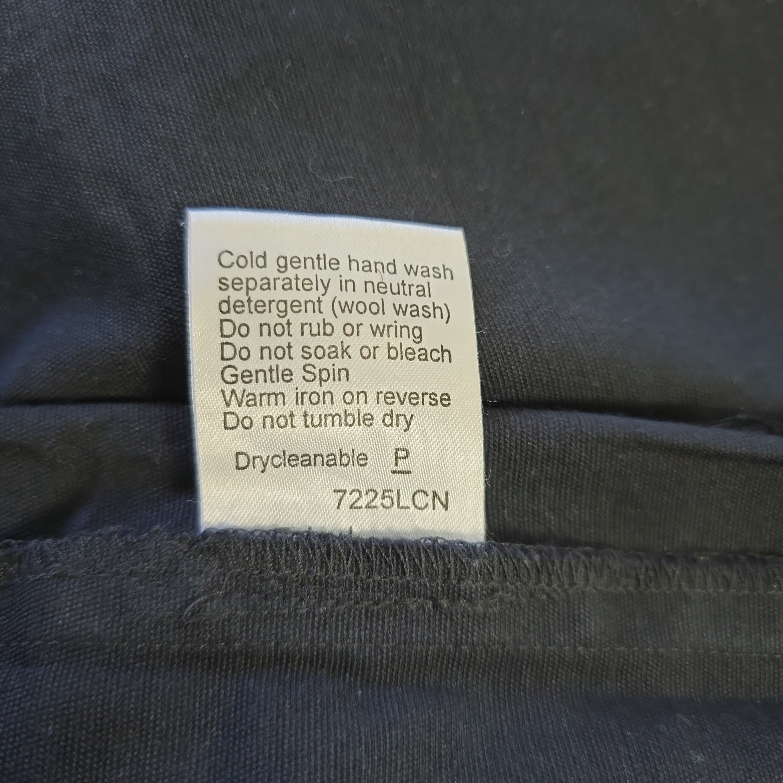 Clothing label on a dark fabric background