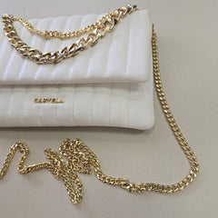 White quilted handbag with gold chain strap on a light gray background