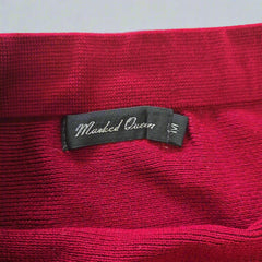 Red textured fabric with a black tag featuring 'Makeda Queen' branding.