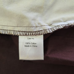 Close-up of a label on a piece of fabric with 'Lisa Ho' branding.