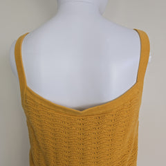 Yellow textured tank top on a mannequin against a neutral background