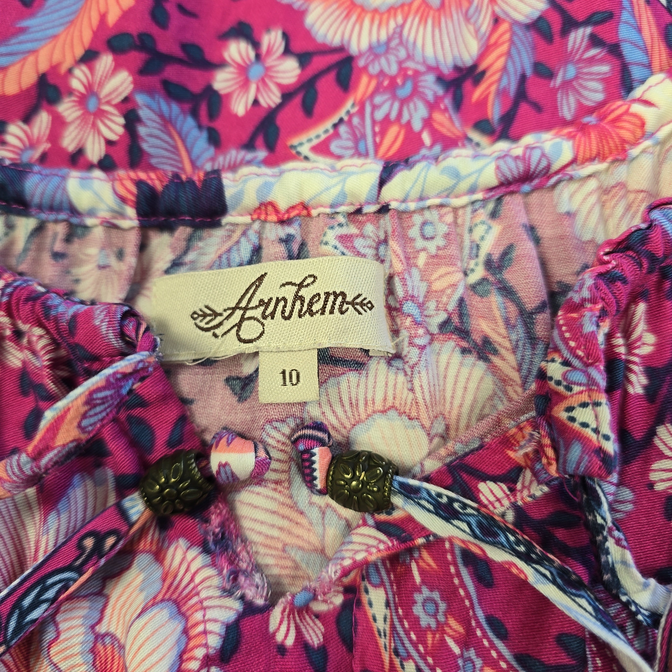 Colorful floral-patterned fabric with a brand tag visible