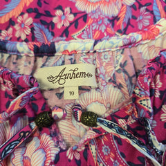 Colorful floral-patterned fabric with a brand tag visible