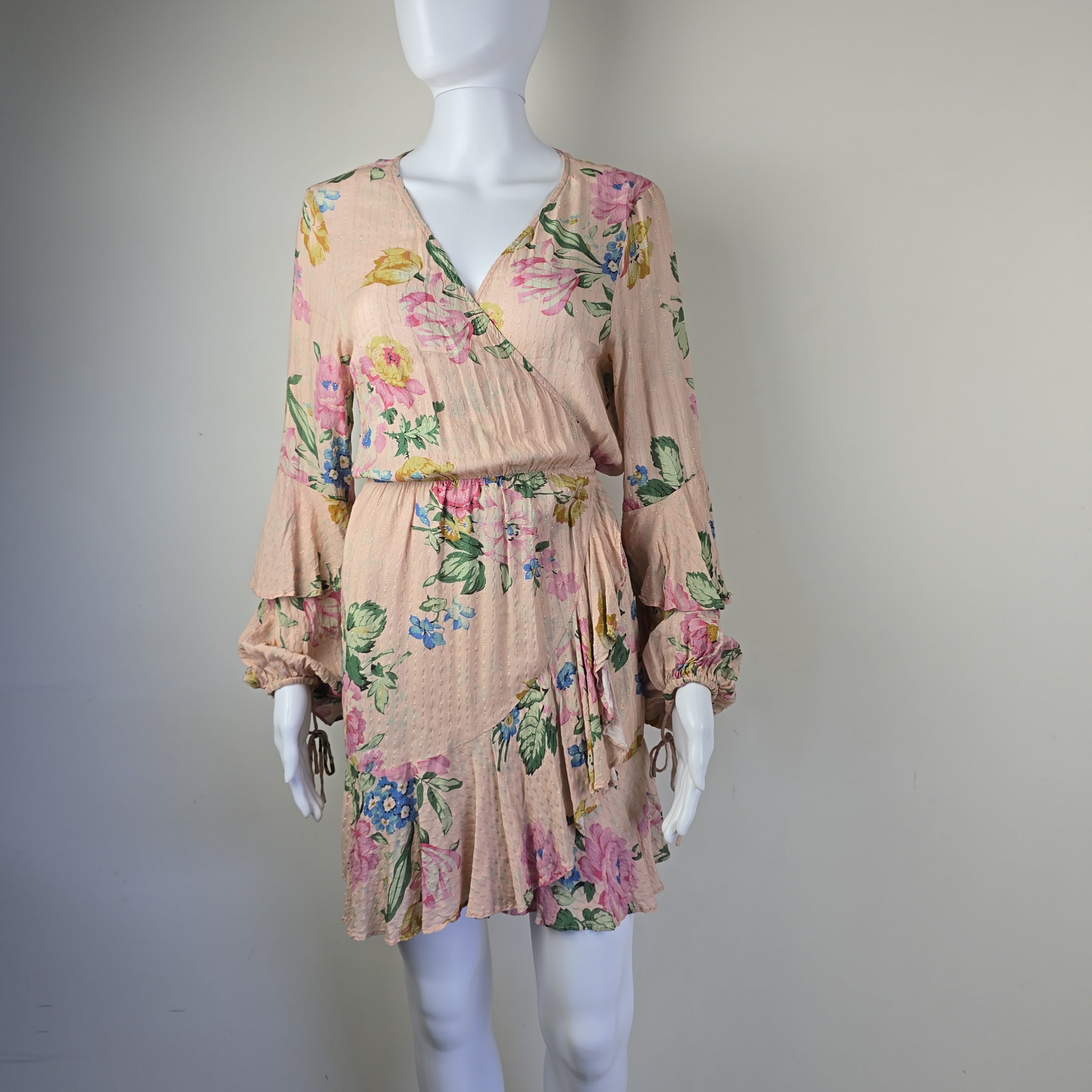 Floral dress on a mannequin against a plain background