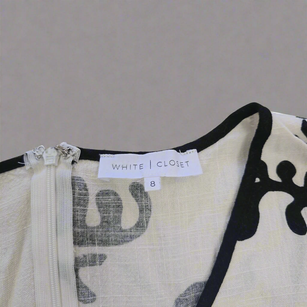 Close-up of a dress with a label on a beige background