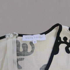Close-up of a dress with a label on a beige background