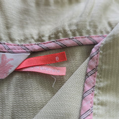Close-up of fabric with a pink label on a textured surface
