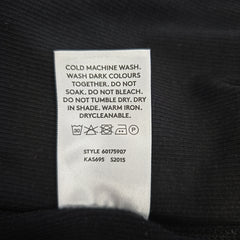 Clothing label with washing instructions on a black background
