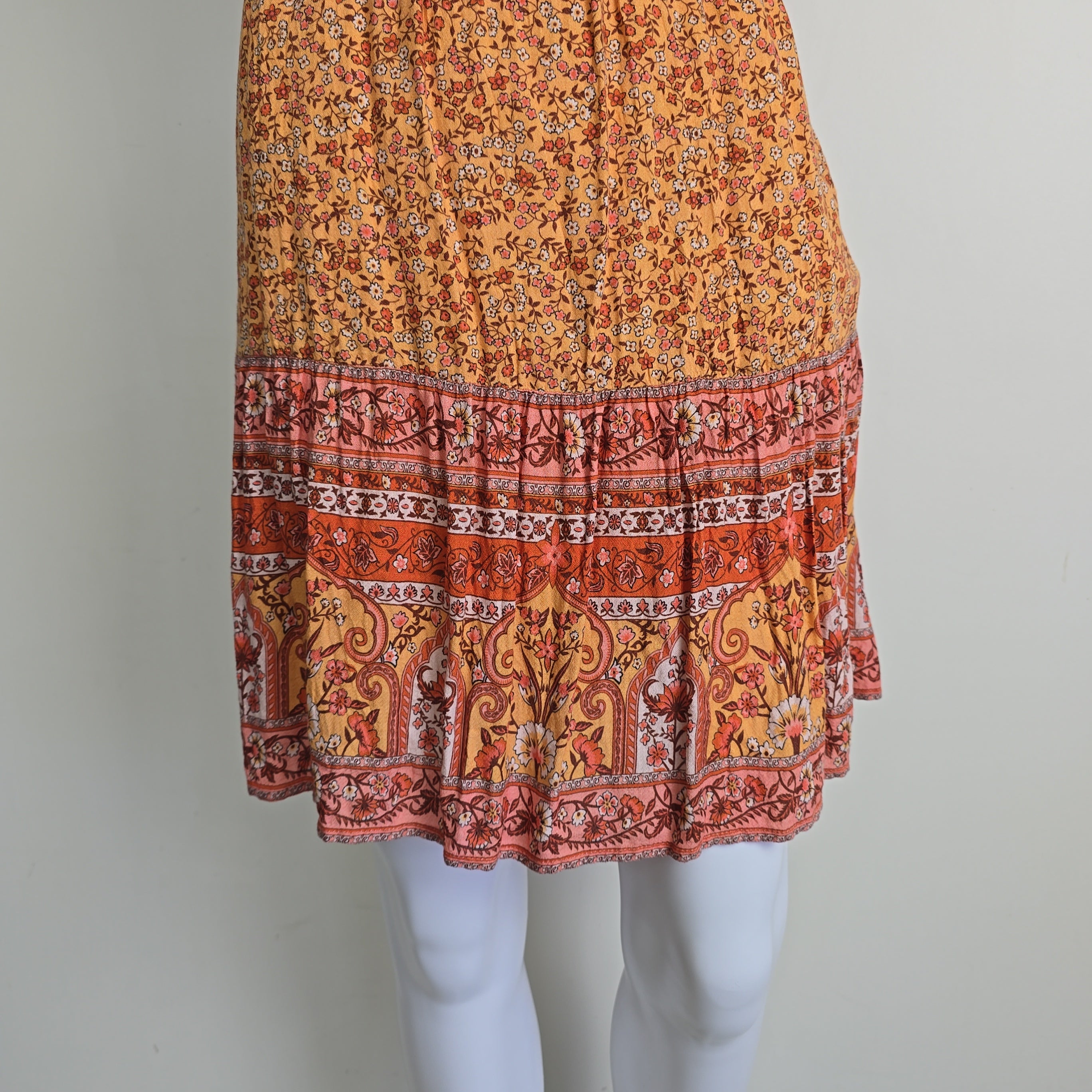 Orange patterned dress on a light background
