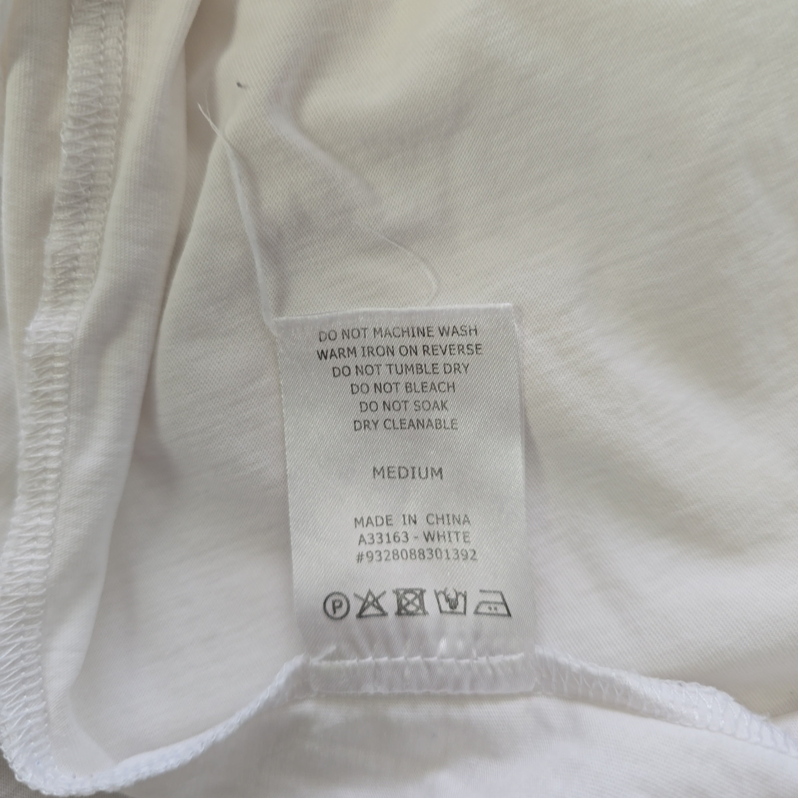Close-up of a clothing label on a white fabric background