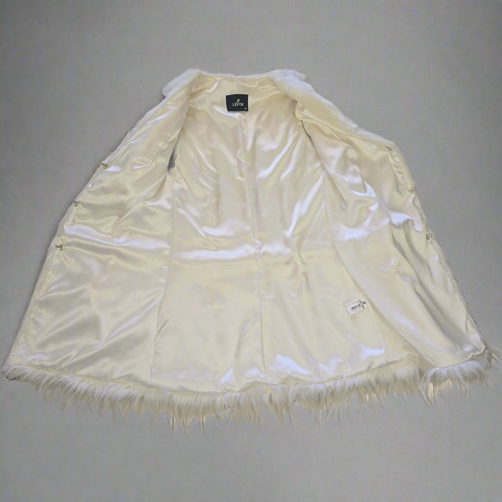 White jacket with frayed edges on a tiled floor
