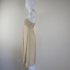 Beige strapless dress on a mannequin against a white background