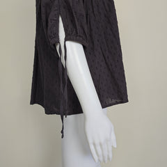 Brown textured fabric on a mannequin against a beige background