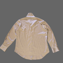 Beige long-sleeve shirt on a tiled floor