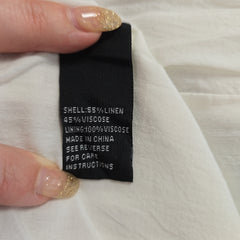 Close-up of a clothing label on a white fabric background
