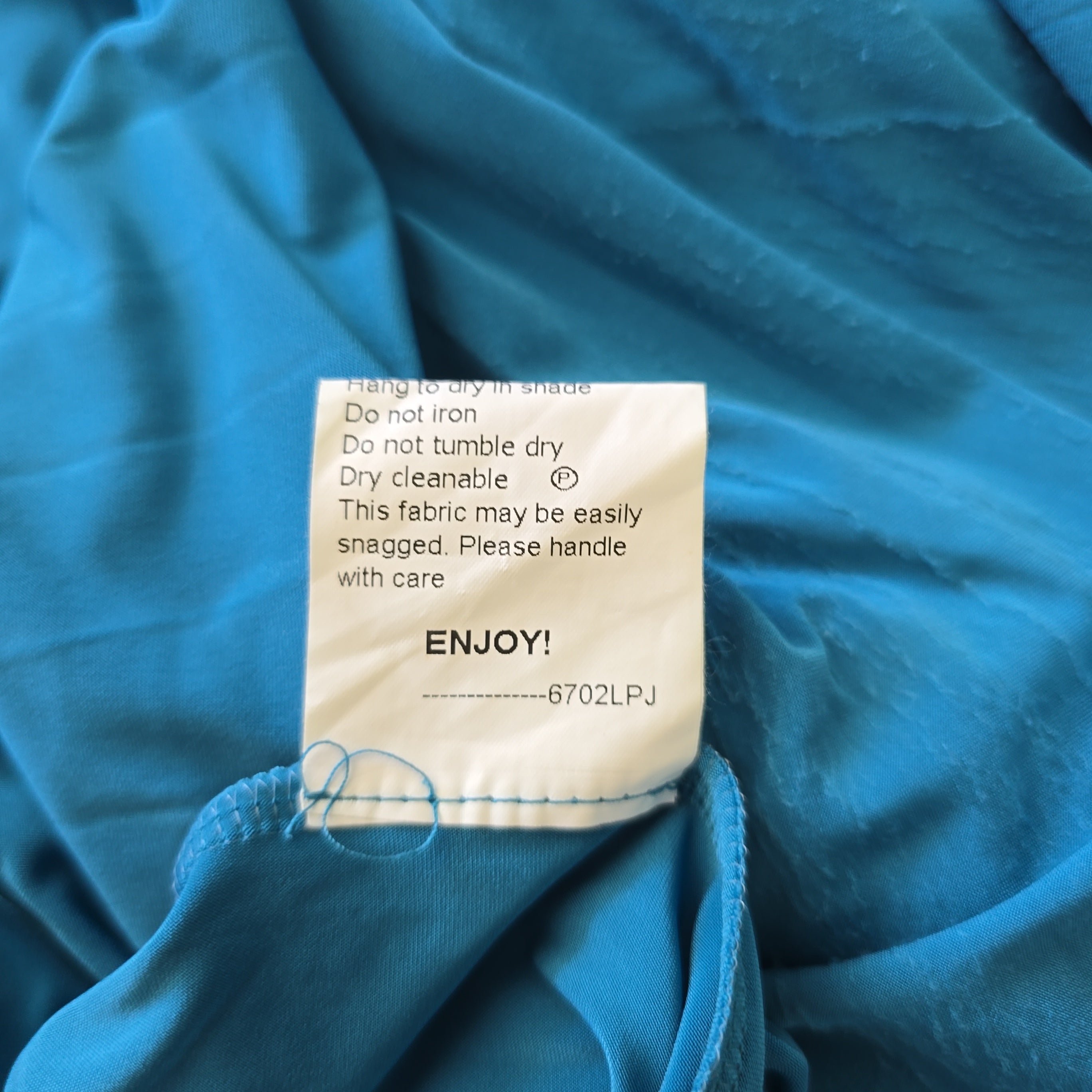 Clothing label on a blue fabric background