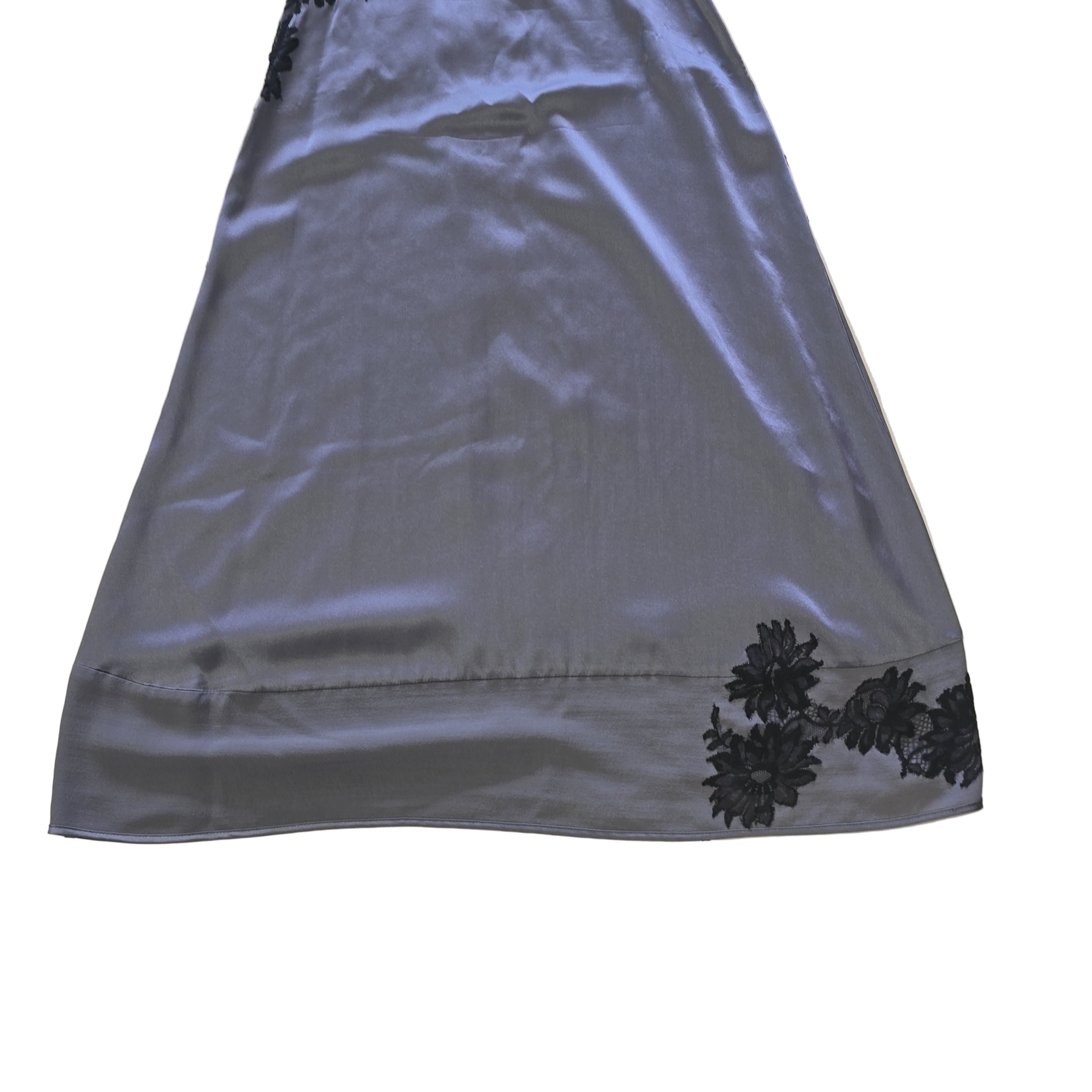 Gray fabric with black floral patterns on a tiled floor