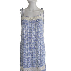 Blue and white patterned fabric draped over a mannequin on a beige background