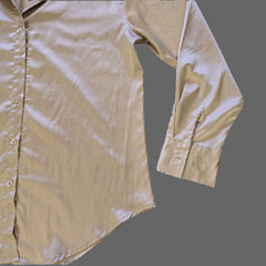 Beige shirt on a tiled floor