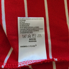 Fabric tag on a red and white striped fabric background