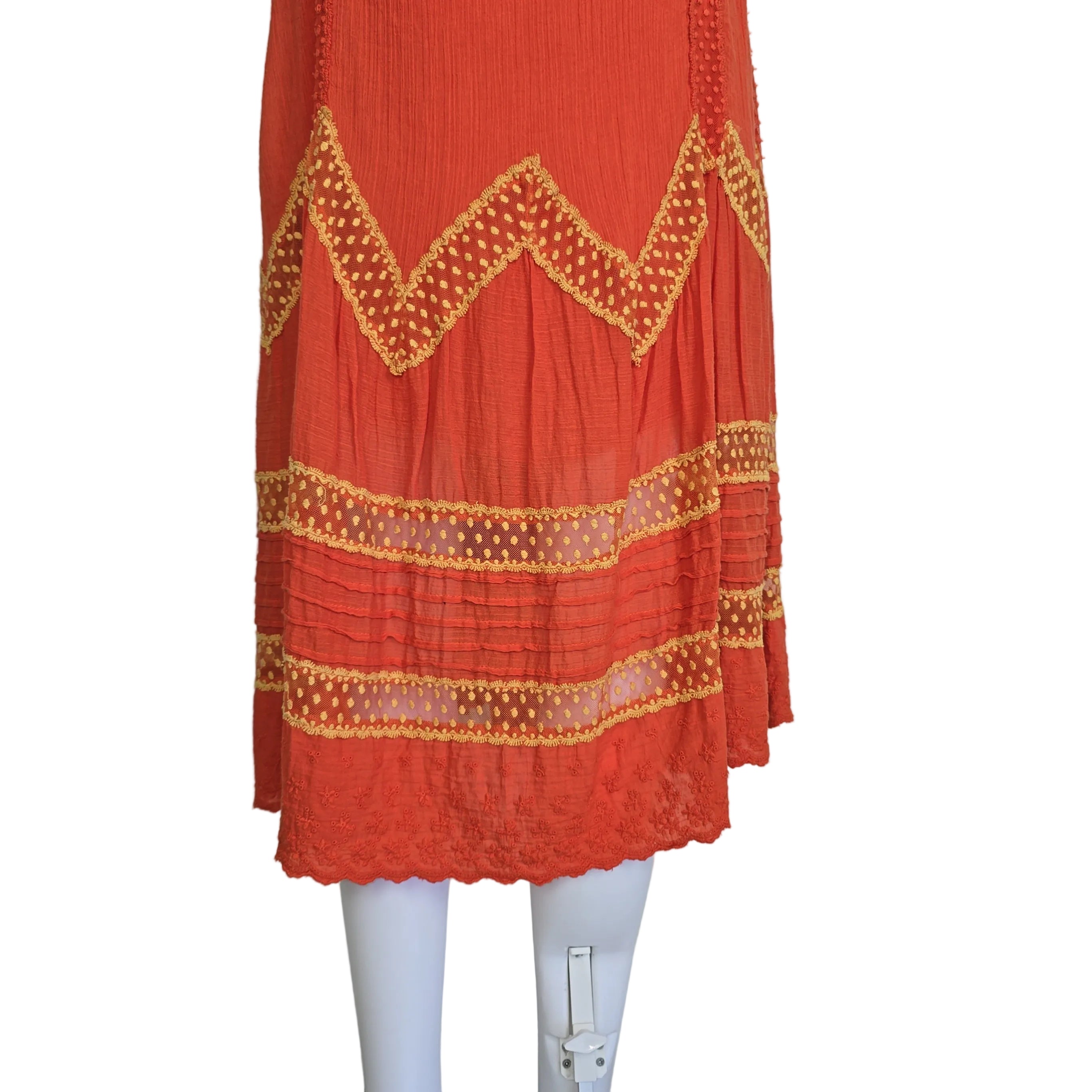 Orange dress with yellow lace embroidery on a light background