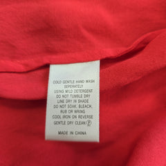 Fabric tag on a red background with text