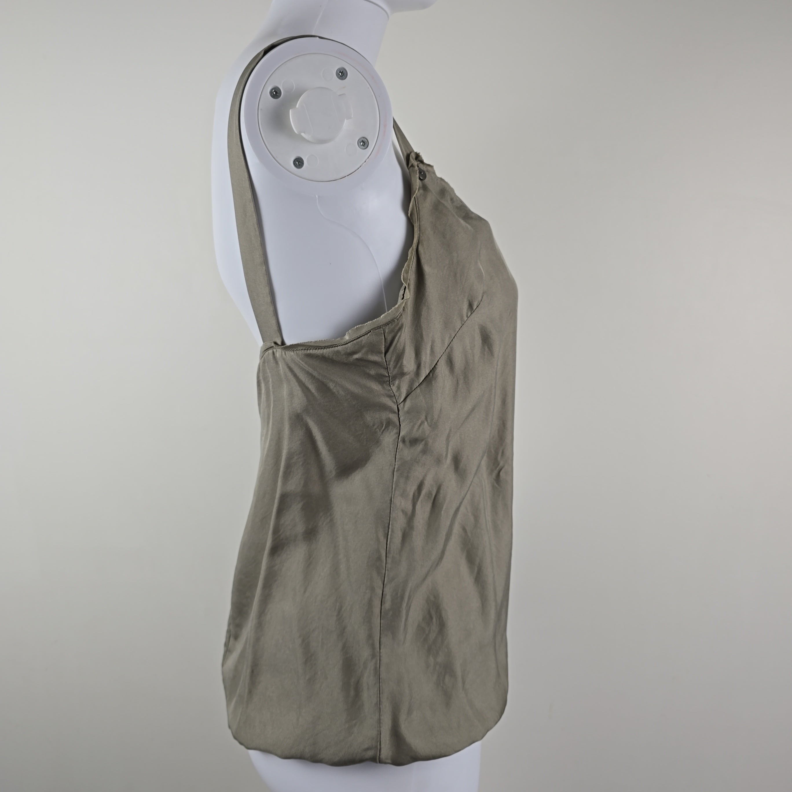 Grey garment on a white mannequin with a gray background