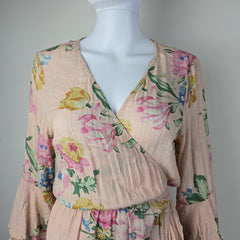 Floral-patterned fabric draped over a mannequin on a plain background