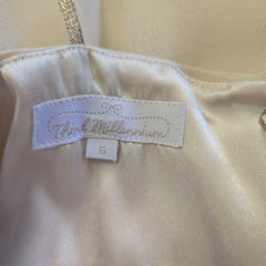 Close-up of a beige top with a label on a beige background