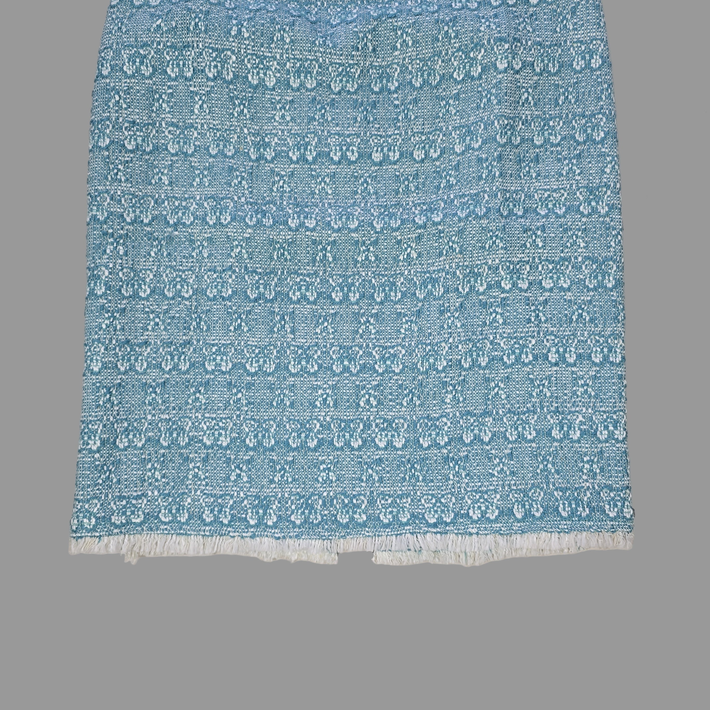 Blue textured skirt on a tiled floor
