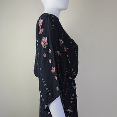 Black dress with white and pink patterns on a light background