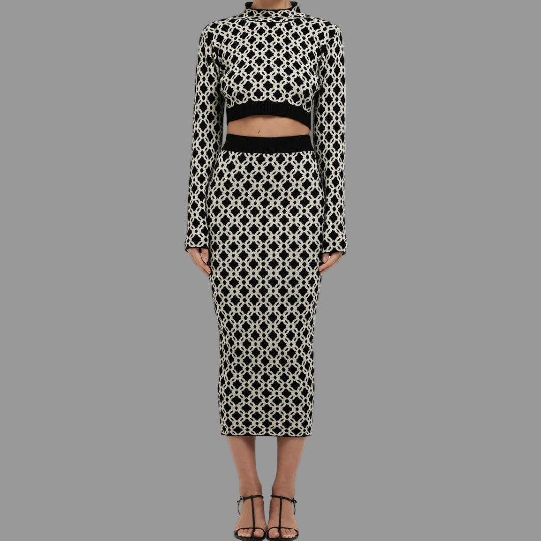 Woman wearing a black and white patterned outfit on a white background