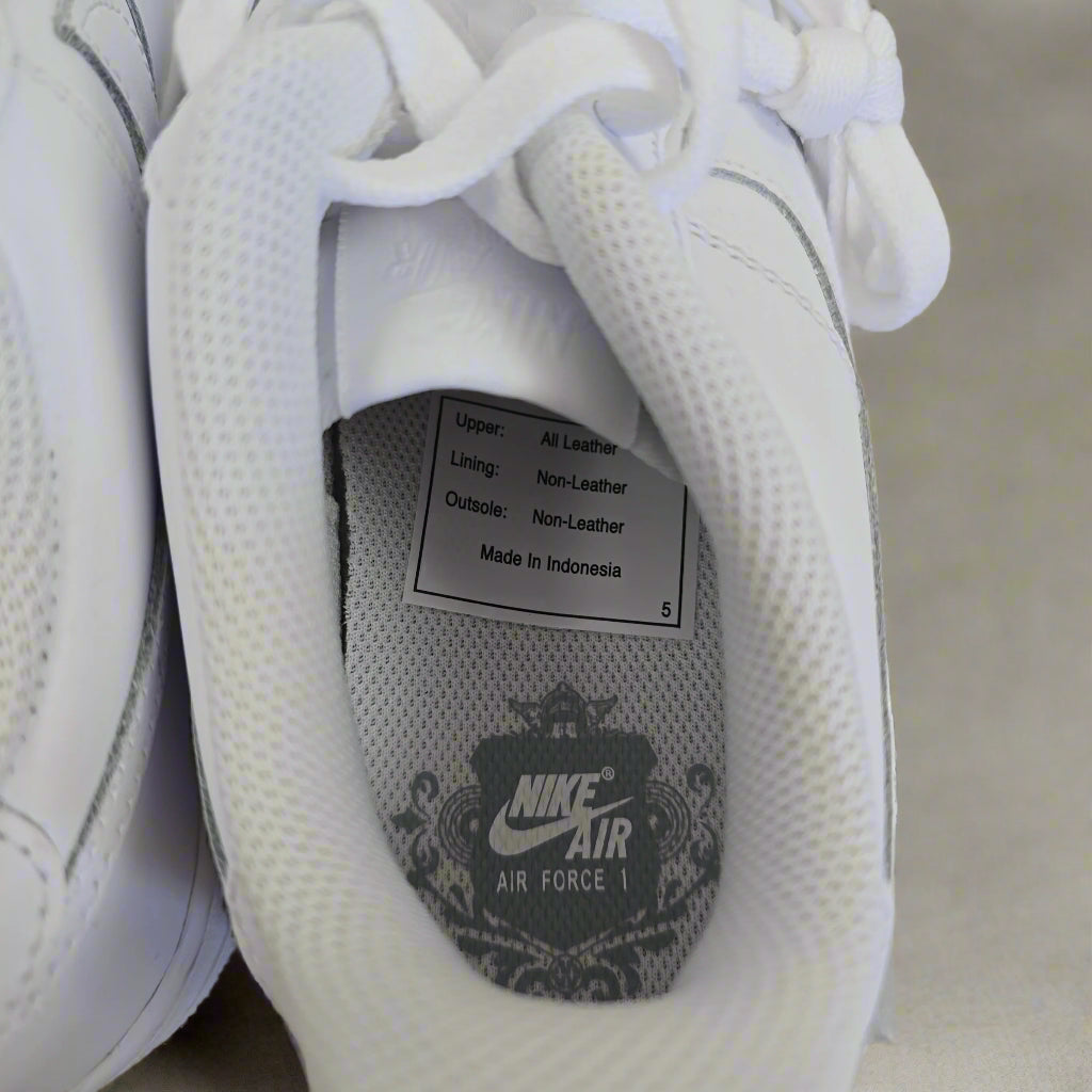 Close-up of a white Nike Air shoe with visible branding and text.