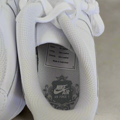 Close-up of a white Nike Air shoe with visible branding and text.