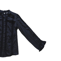 Black long sleeved button up top with black lace details on a light background