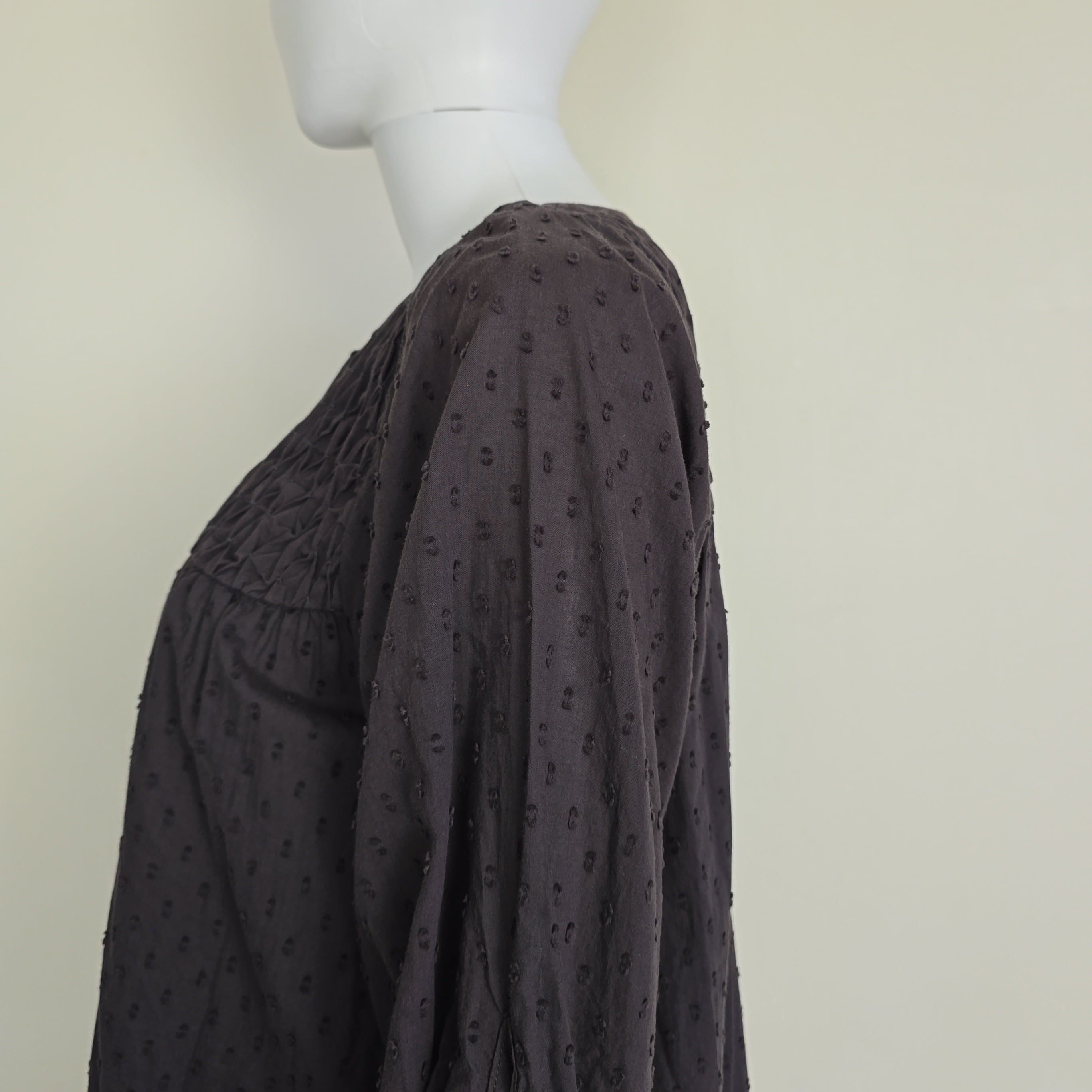 Brown long-sleeve top on a light background