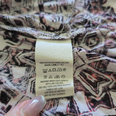 Close-up of a patterned fabric with a visible label.