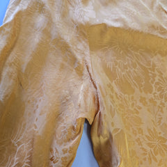 Yellow floral fabric with a visible seam on a blue background