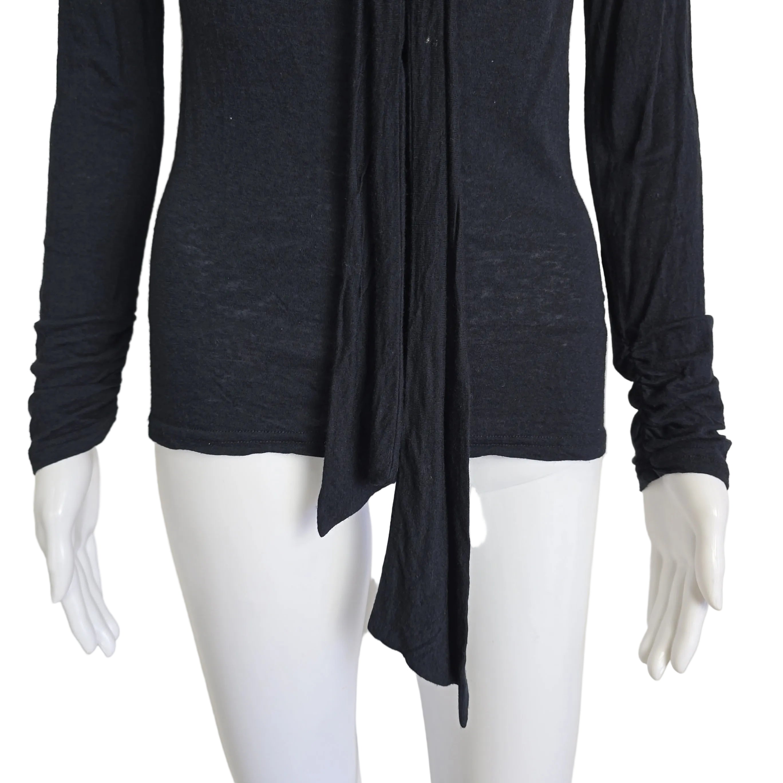 Black long-sleeve top on a mannequin against a beige background