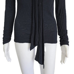 Black long-sleeve top on a mannequin against a beige background